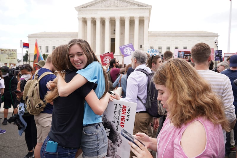 Pro-life supporters celebrate outside the court. AFP