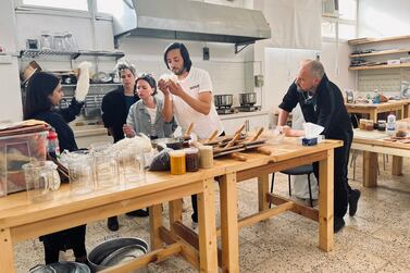 The artists take part in a workshop using traditional dyeing techniques, organised by the Prince's Foundation School of Traditional Arts at the Madrasat AdDeera, AlUla’s arts & design centre. From left to right: Yusra Al-Anesi, Sara Favriau, Talin Hazbar, Sofiane Si Merabet, Muhannad Shono. Photo by Anais Veignant, Courtesy of the artists, The Prince's Foundation School of Traditional Arts and Manifesto