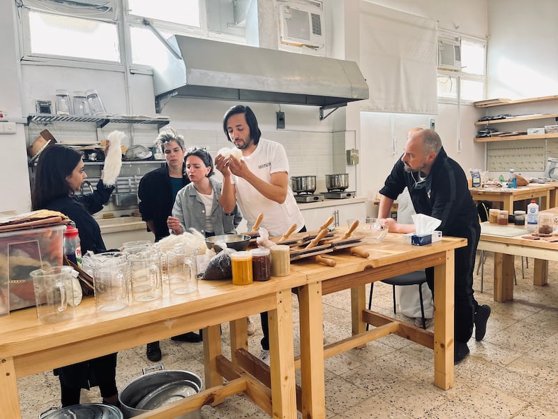 From left, artists Yusra Al-Anesi, Sara Favriau, Talin Hazbar, Sofiane Si Merabet and Muhannad Shono take part in a workshop organised by the Prince's Foundation School of Traditional Arts at the Madrasat AdDeera, AlUla’s arts and design centre. Photo: Anais Veignant; The Prince's Foundation School of Traditional Arts; Manifesto