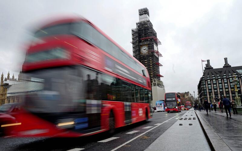 A red London bus is driven over Westminster Bridge past the Houses of Parliament in central London on January 16, 2019. The British pound firmed against the dollar and euro Wednesday, and London stocks dropped, as traders awaited a confidence vote on British Prime Minister Theresa May's government after parliament voted massively against its Brexit deal. / AFP / Tolga AKMEN
