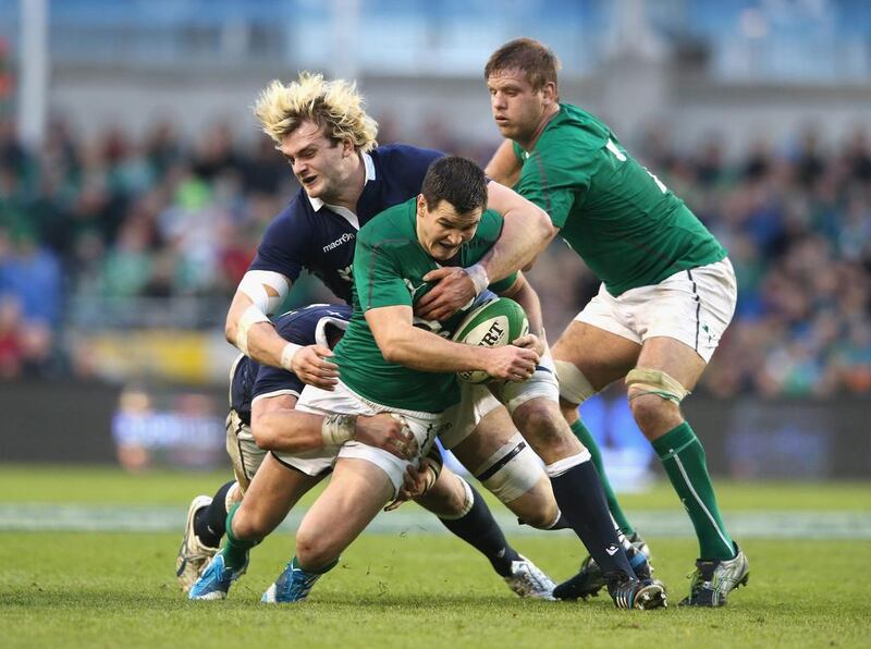 Johnny Sexton of Ireland is tackled by Richie Gray of Scotland during their Six Nations match at the Aviva Stadium in Dublin on February 2, 2014. David Rogers / Getty Images