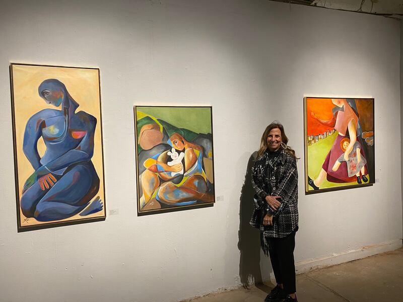 Monelle Janho with her paintings 'Bleu dans le Coeur', 'I am a Child' and 'Some Fears'