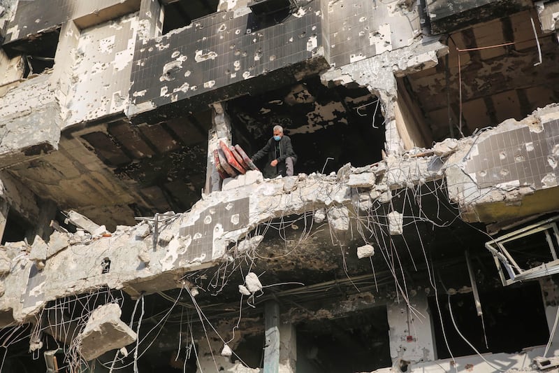 A man inspects the damage caused by Israeli air strikes at the hospital. The Gaza Health Ministry says at least 300 people were killed in the two-week Israeli operation. AFP