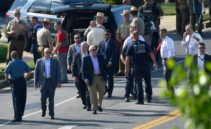 Maryland Gov. Larry Hogan, center in sunglasses, surveys the scene of a shooting in Annapolis, Md., Thursday, June 28, 2018. (AP Photo/Susan Walsh)