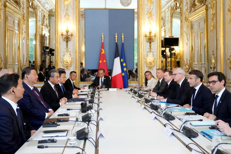 Mr Xi and Mr Macron with their delegations at a working session at the Elysee Palace. EPA
