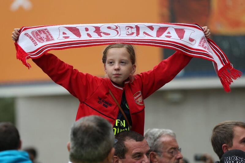 An Arsenal fan holds her scarf up outside the stadium before the Premier League match against Hull City. Alex Morton / Getty Images