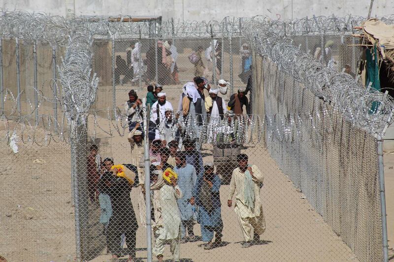 Afghans arrive in Pakistan through the Pakistan-Afghanistan border crossing point in Chaman, following the Taliban takeover of Afghanistan. AFP