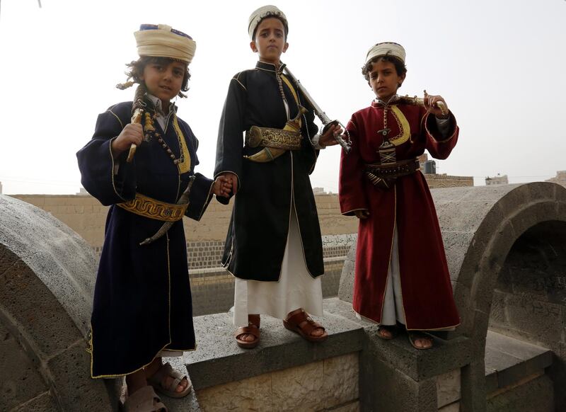 Three children wear traditional wedding attire prior to a wedding ceremony in the old quarter of Sanaâa, Yemen.  EPA