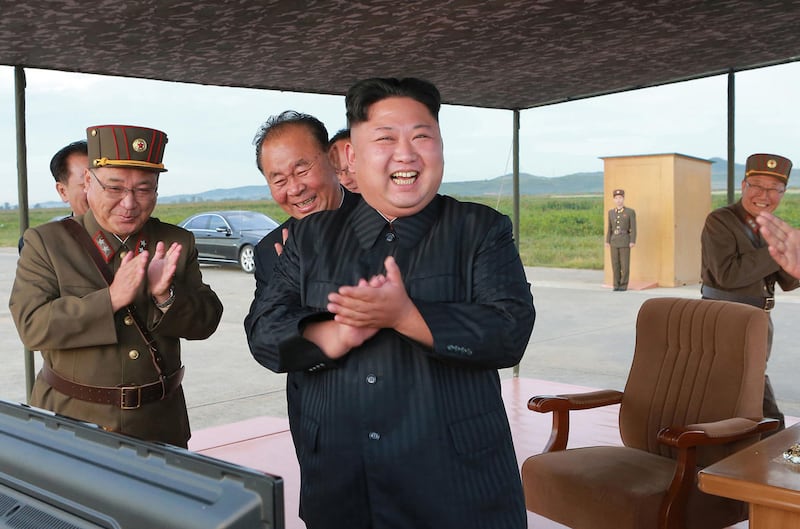 In this undated file photo distributed on Saturday, Sept. 16, 2017, by the North Korean government, North Korean leader Kim Jong Un, center, celebrates what was said to be the test launch of an intermediate range Hwasong-12 missile at an undisclosed location in North Korea. Independent journalists were not given access to cover the event depicted in this image distributed by the North Korean government. The content of this image is as provided and cannot be independently verified. (Korean Central News Agency/Korea News Service via AP, File)
