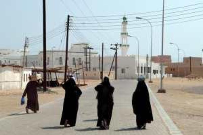 Local Omani women walk under electrical power lines stretched across the streets of Sur in the southern Sultanate of Oman early September 2006. La Boudeuse, captained by French explorer Patrice Franceschi, arrived from Indonesia after it crossed the Indian ocean as part of the eighth of 12 sailing expeditions around the world which focus on the re-discovery of the "people of the water". AFP PHOTO ERIC FEFERBERG