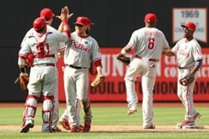 Eric Bruntlett, third from left, celebrates with his fellow Phillies after completing an unassisted triple play against the Mets at Citi Field on Sunday. The rare feat capped a memorable day for Bruntlett.