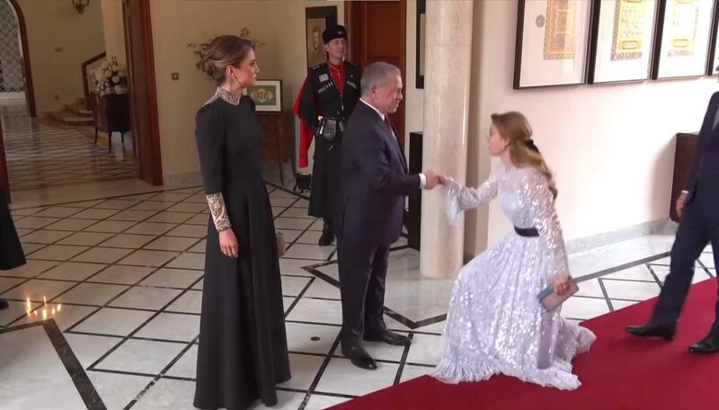 Britain's Princess Beatrice, in a sequined Needle & Thread gown and Sophia Webster clutch, greets the Jordanian king and queen 