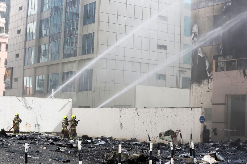 Dubai Civil Defence personnel try to quell the fire.