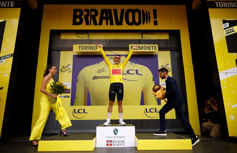 EF Education-EasyPost's Richard Carapaz celebrates on the podium after capturing the yellow jersey from UAE Team Emirates' Tadej Pogacar. Reuters