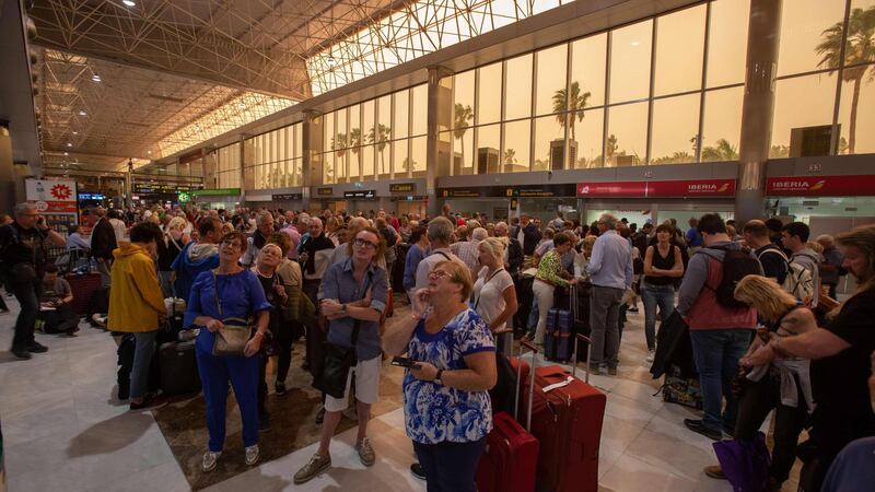 Passengers wait at Tenerife South–Reina Sofia Airport after flights were cancelled due to a sandstorm on February 23, 2020 on the Canary Island of Tenerife. AFP