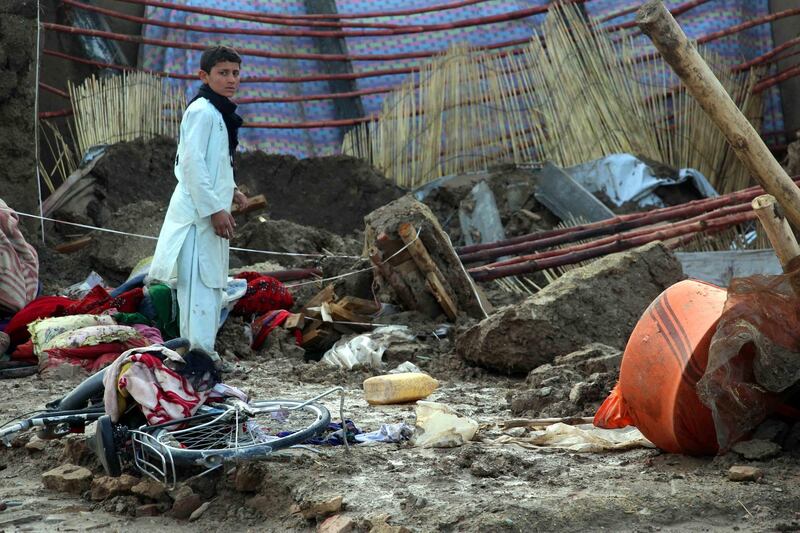 People salvage their belongings after flash floods in Kandahar, Afghanistan on March 2, 2019. EPA