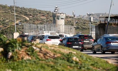 Palestinians wait in traffic at a checkpoint leading out of Nablus. EPA