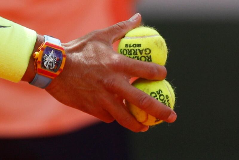 Nadal holds tennis balls during the match. Reuters