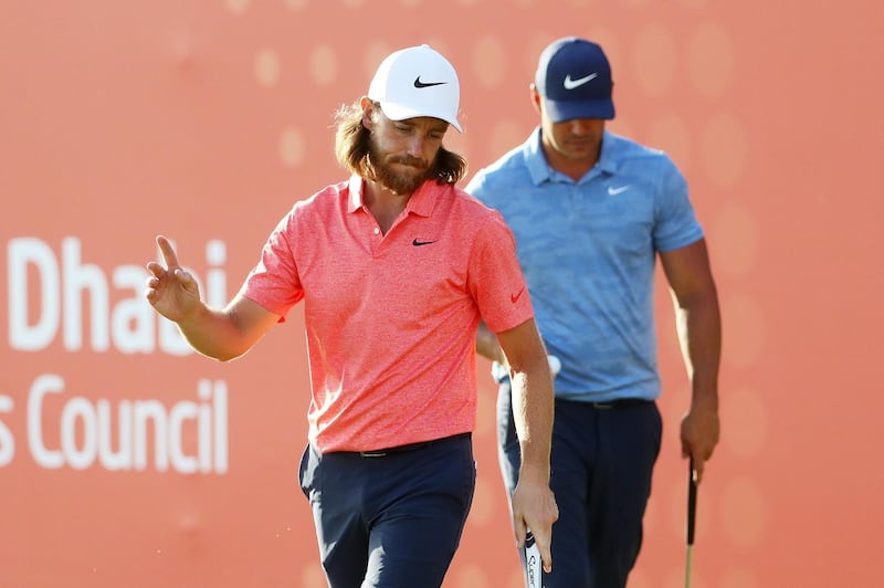 ABU DHABI, UNITED ARAB EMIRATES - JANUARY 17: Tommy Fleetwood of England reacts on the 18th green as Brooks Koepka of the United States looks on during Day Two of the Abu Dhabi HSBC Golf Championship at Abu Dhabi Golf Club on January 17, 2019 in Abu Dhabi, United Arab Emirates. (Photo by Warren Little/Getty Images)