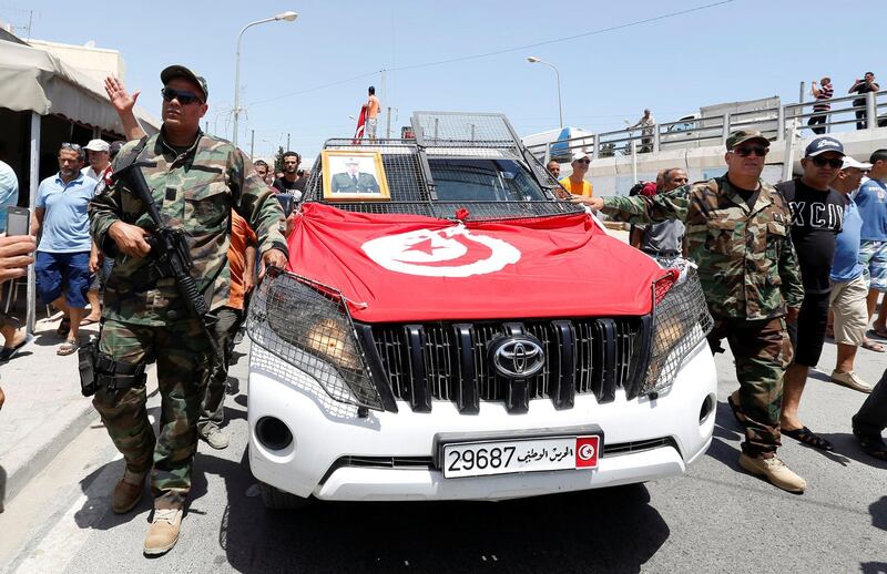 Police officers walk in front of the coffin of Anis El Werghi, a Tunisian security forces member who was killed in an ambush in the northwest of the country. Reuters