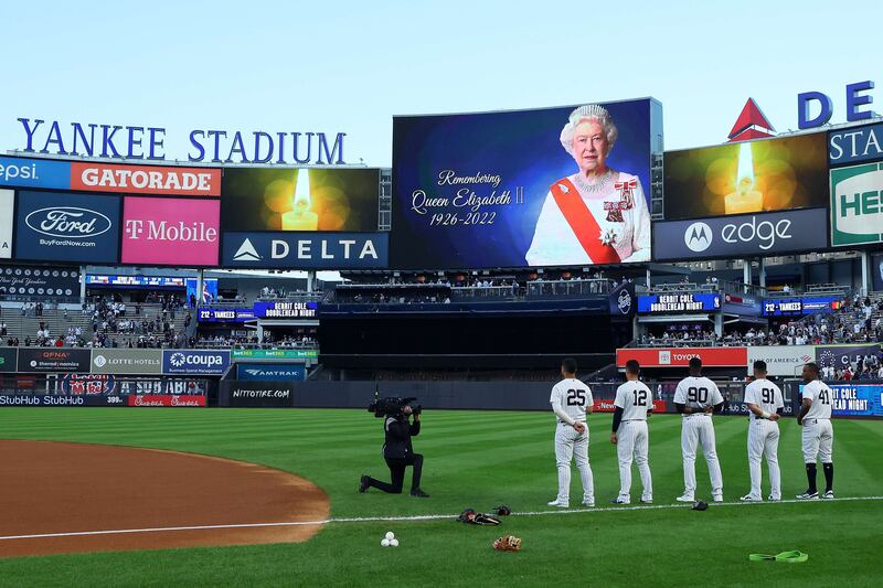 Members of the New York Yankees stand during a moment of silence in honour of Queen Elizabeth before the game against the Minnesota Twins at Yankee Stadium. Getty Images / AFP