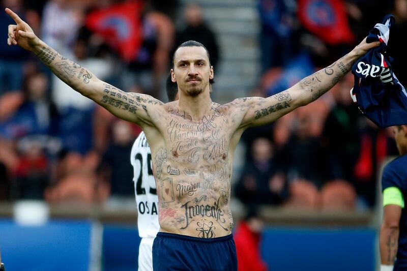 Paris Saint-Germain's Swedish forward Zlatan Ibrahimovic celebrates after scoring during the French L1 football match Paris Saint-Germain (PSG) vs Caen (SMC) at the Parc des Princes stadium in Paris on February 14, 2015. The match ended in a 2-2 draw. AFP PHOTO / KENZO TRIBOUILLARD (Photo by KENZO TRIBOUILLARD / AFP)