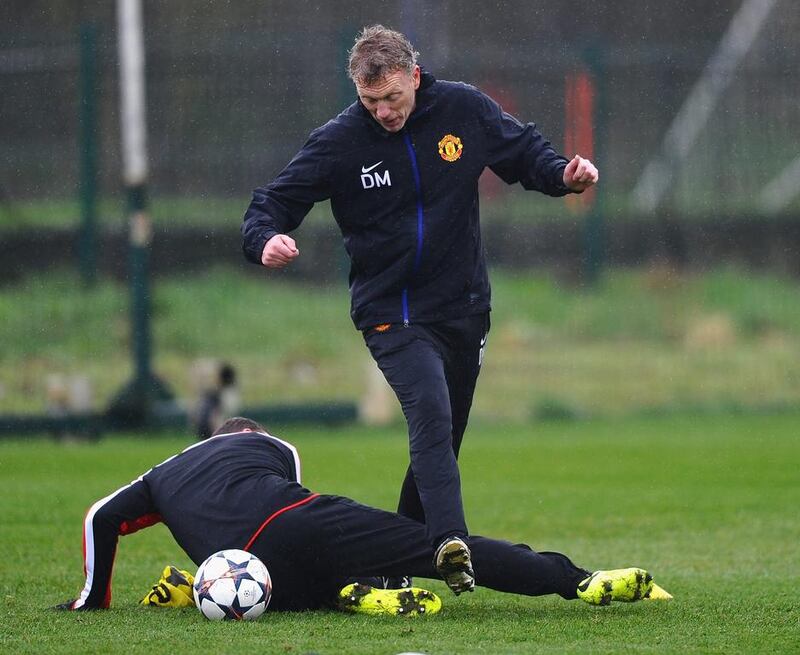 David Moyes avoiding Wayne Rooney's challenge during Tuesday's training session. Laurence Griffiths / Getty Images/ March 18, 2014