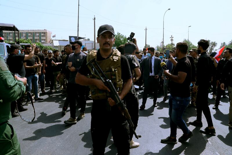Members of Iran-backed militia groups march in central Baghdad, Iraq. AP