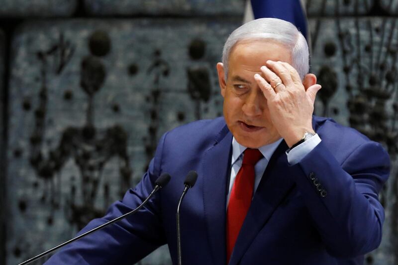 Israeli Prime Minister Benjamin Netanyahu gestures as he speaks during a ceremony whereby Amir Yaron is sworn in as Bank of Israel governor, in Jerusalem December 24, 2018. REUTERS/Amir Cohen