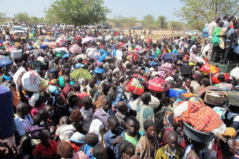 Civilians gather outside a UN compound in Bor, believed captured by forces loyal to fugitive former vice president Riek Machar. Rolla Hinedi / AFP



