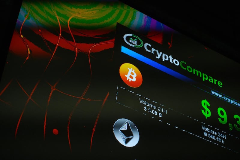 The symbols of Bitcoin and Ethereum cryptocurrencies sit displayed on a screen during the Crypto Investor Show in London, U.K., on Saturday, March 10, 2018. The meeting is the largest crypto and blockchain event for investors in the U.K. Photographer: Mary Turner/Bloomberg