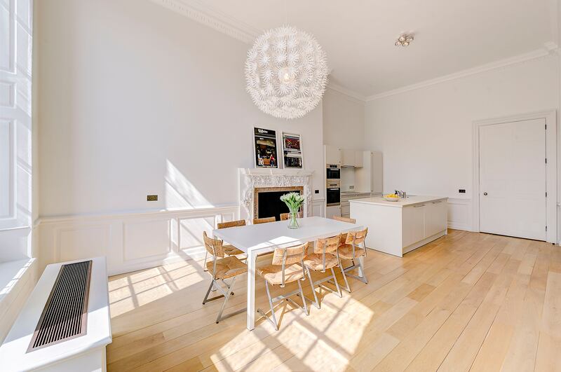 The bright kitchen features a fireplace