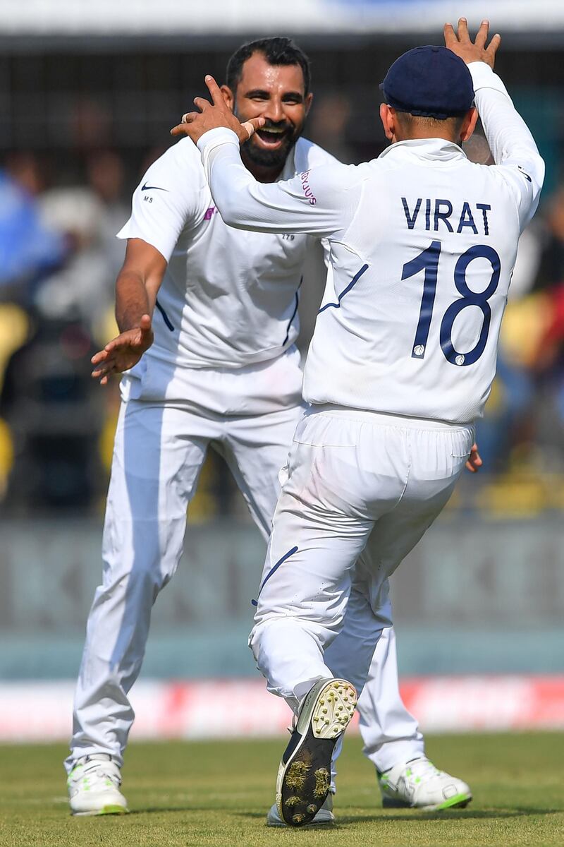 India's cricketer Mohammed Shami (L) jumps celebrates with captain Virat Kohli after the dismissal of Bangladesh's Mushfiqur Rahim during the first day of the first Test cricket match between India and Bangladesh at the Holkar Cricket Stadium in Indore on November 14, 2019.   - ----IMAGE RESTRICTED TO EDITORIAL USE - STRICTLY NO COMMERCIAL USE----- / GETTYOUT
 / AFP / Indranil MUKHERJEE / ----IMAGE RESTRICTED TO EDITORIAL USE - STRICTLY NO COMMERCIAL USE----- / GETTYOUT

