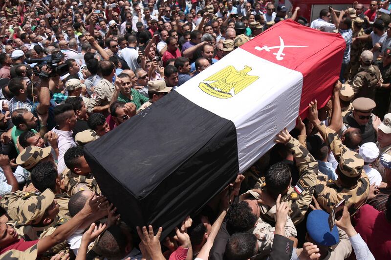 Egyptians carry the coffin of a soldier who was killed a day earlier in the restive Sinai Peninsula in an attack by ISIL, during a funeral ceremony in the 10th of Ramadan city, about 60km north of Cairo, on July 8, 2017. Mahmoud Bakkar / AFP