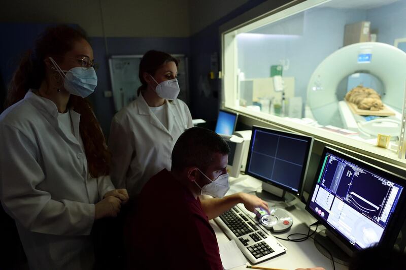 Medics monitor the results of the CT scan.