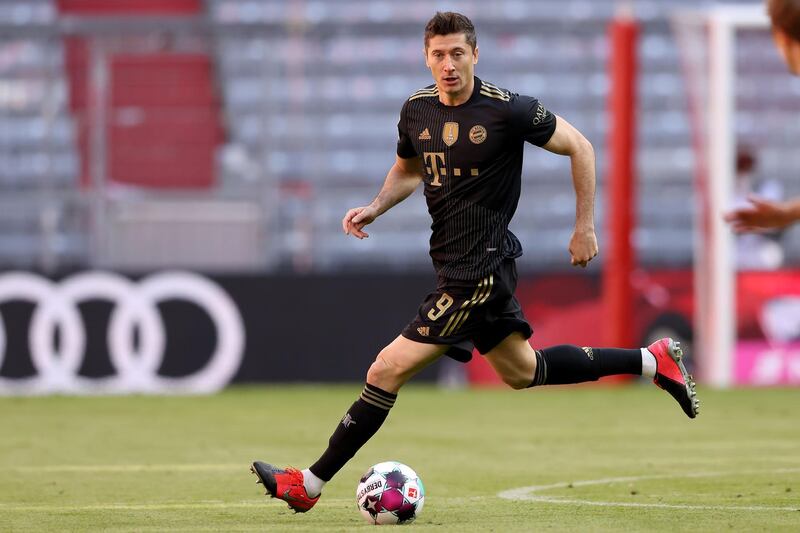 MUNICH, GERMANY - MAY 22: Robert Lewandowski of FC Bayern MÃ¼nchen runs with the ball during the Bundesliga match between FC Bayern Muenchen and FC Augsburg at Allianz Arena on May 22, 2021 in Munich, Germany. After the Bavarian cabinet decided on first relaxations for outdoor events, the current Corona situation allows FC Bayern to have its last match of the season in front of 250 spectators in the Allianz Arena. Of these, 100 tickets are given to people from the health sector selected by the Ministry of Health. (Photo by Alexander Hassenstein/Getty Images)