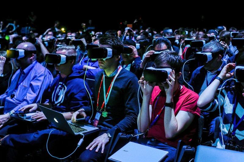 Visitors test out the VR headsets which connect to the S7. David Ramos / Getty Images