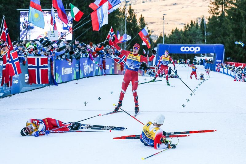 Russia's Alexander Bolshunov claims third place in the FIS Nordic World Cup 10km cross country, with race winner Simen Hegstad Krueger and second placed Sjur Roethe - both from Norway - slumped on the ground. The event took place on Sunday, January 5 in Val Di Fiemme, Italy. Getty