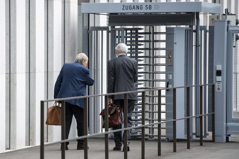 Blatter and his lawyer Lorenz Erni arrive in front of the building. EPA