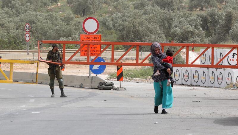 Israeli troops close off the main entrance to Azzun, near the West Bank city of Qalqilya, after Adwan was killed early on Saturday.   EPA 