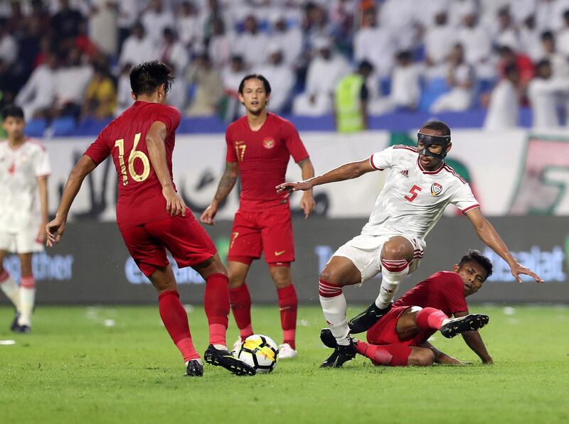 Dubai, United Arab Emirates - October 10, 2019: Ali Hassan Al Blooshi of the UAE and Zulfiandi of Indonesia during the Qatar 2022 world cup qualifier between The UAE and Indonesia. Thursday 10th of October. Al Maktoum Stadium, Dubai. Chris Whiteoak / The National