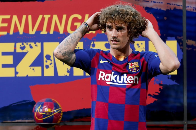 Antoine Griezmann poses for the media during his presentation as a a Barcelona player at Camp Nou. EPA