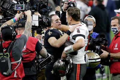 New Orleans Saints quarterback Drew Brees, center left, speaks with Tampa Bay Buccaneers quarterback Tom Brady after an NFL divisional round playoff football game, Sunday, Jan. 17, 2021, in New Orleans. The Buccaneers won 30-20. (AP Photo/Butch Dill)