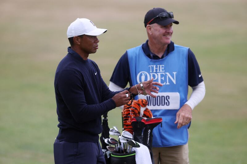 Tiger Woods with his caddy during practice. Reuters