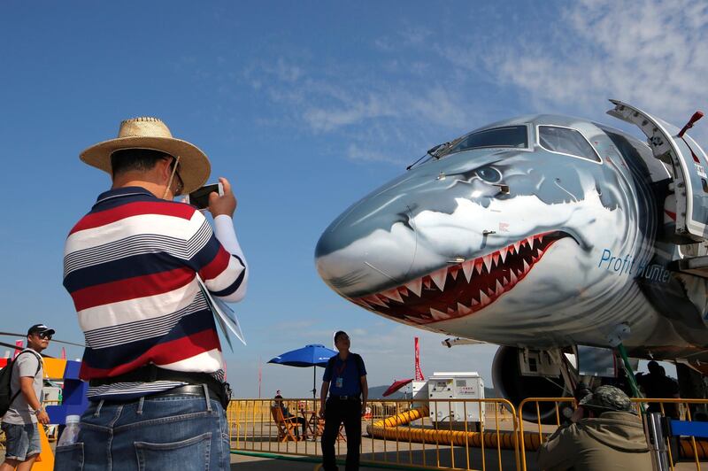 A man takes photo of the Embraer E190-E2 Commercial Jet. AP Photo