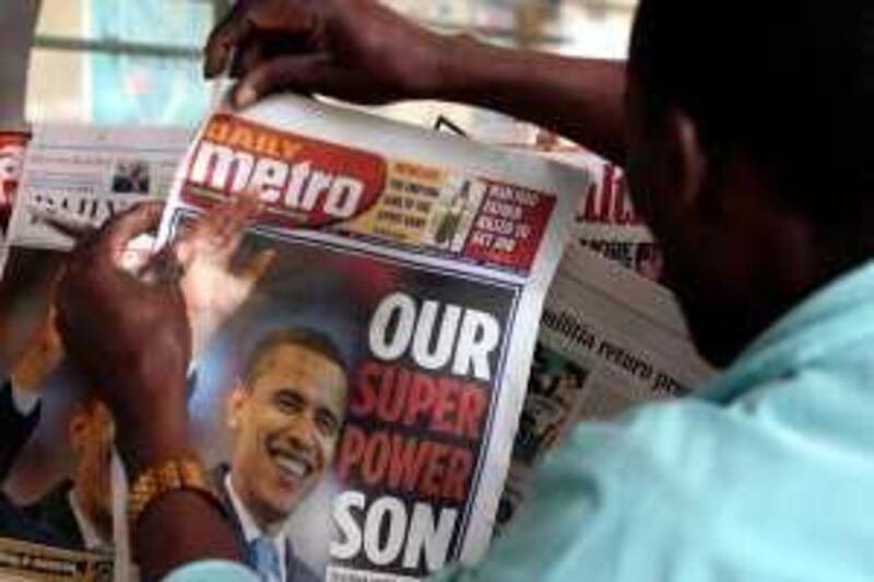 A Kenyan man buys a local newspapers selling in the streets of Nairobi with the front page on June 5, 2008 of US Democratic presidential candidate Senator Barack Obama,after his nomination victory that places him a heartbeat away from White House  . AFP PHOTO/SIMON MAINA
