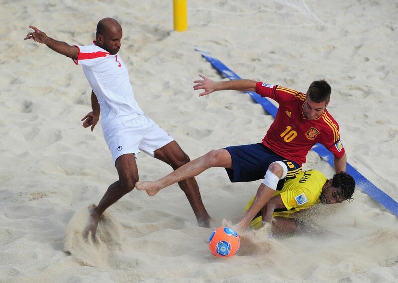 Llorenc, of Spain, is challenged by Mohamed Al Jasmi, the UAE goalkeeper, and Qambar Mohammad Sadeqi during their Beach Soccer World Cup match. Shaun Botterill / Fifa / Fifa via Getty Images