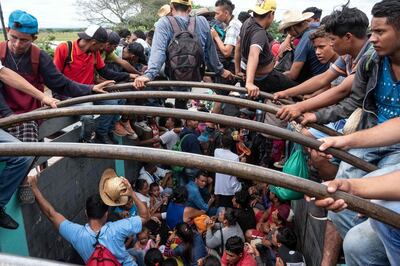 TOPSHOT - Migrants -mostly Hondurans- heading in a caravan to the US, are seen onboard a truck as they catch a ride in Isla, Veracruz state, on their way to Puebla, Mexico, on November 3, 2018.  President Donald Trump on Thursday warned that soldiers deployed to the Mexican border could shoot Central American migrants who throw stones at them while attempting to cross illegally. / AFP / Guillermo Arias
