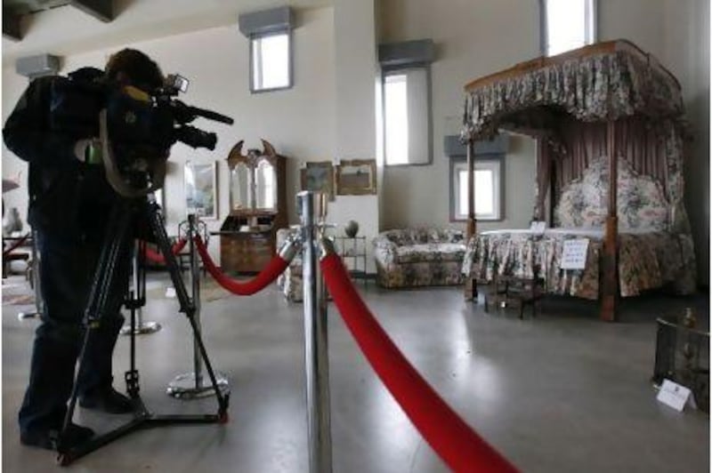 A cameraman films a bedroom set belonging to Bernard Madoff ahead of the US Marshals Service auction.