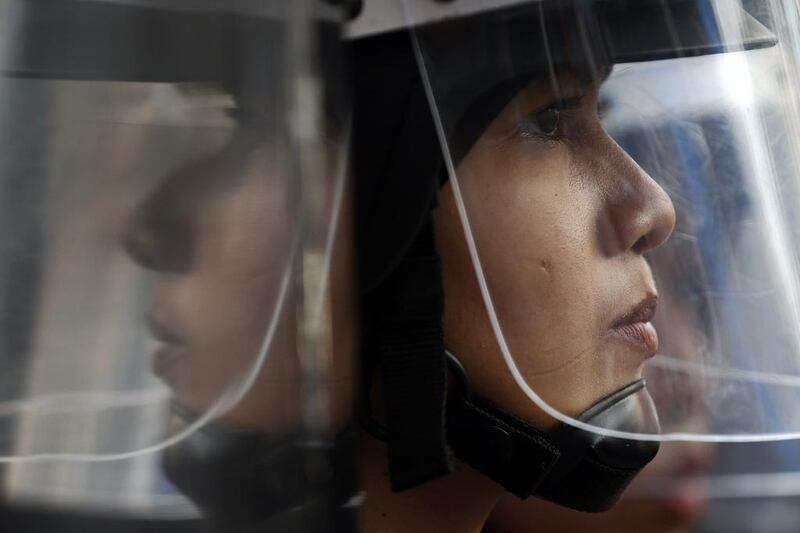 A policewoman looks on during a protest against military rule in Bangkok. Former prime minister Yingluck Shinawatra was in a “safe place” on Saturday, an aide said, after being held by Thailand’s army following its seizure of power this week, as opposition to the coup grew among her supporters and pro-democracy activists. Damir Sagol / Reuters